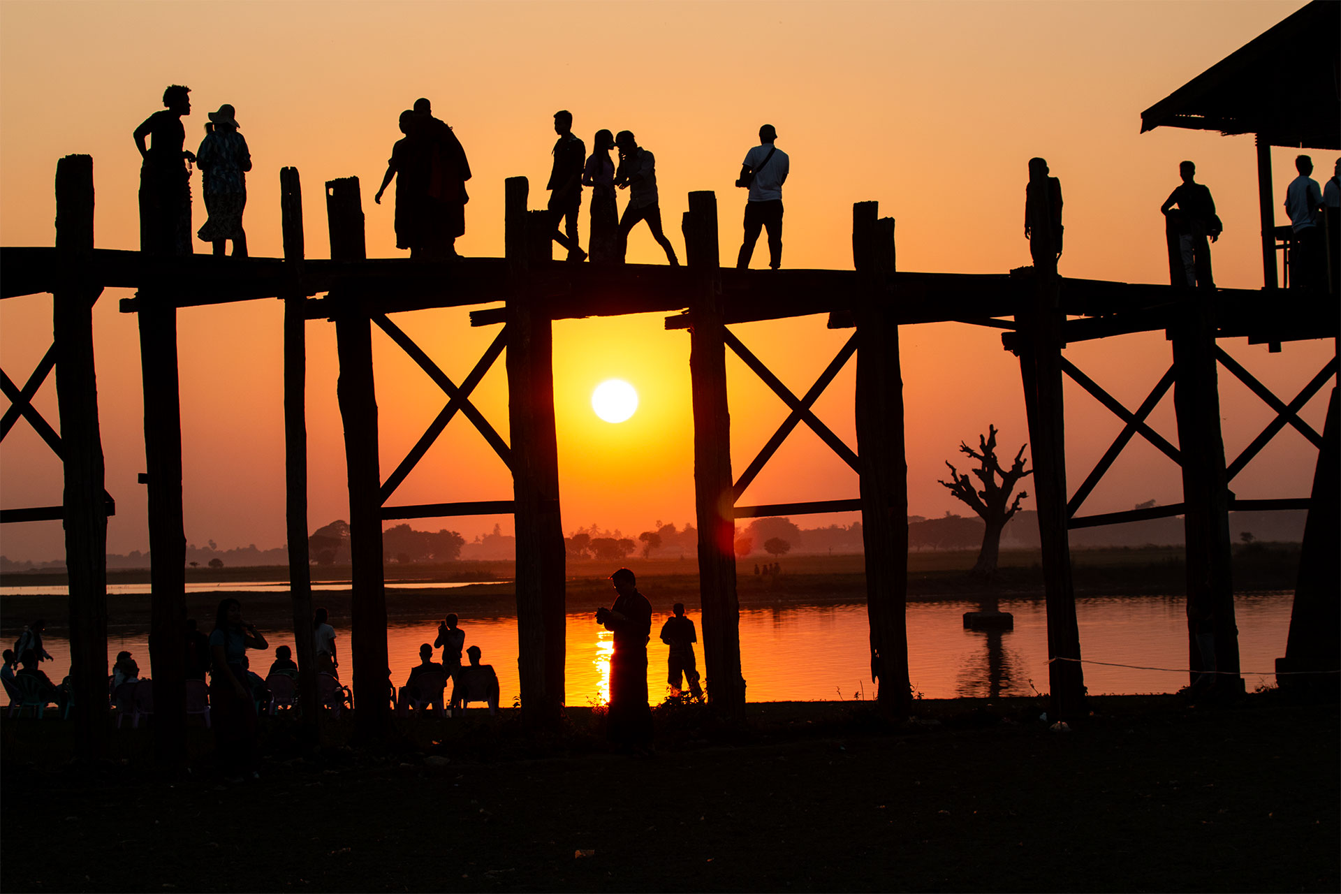 people on a bridge in sunset